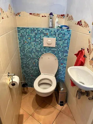 a bathroom with a toilet and a sink at Terraced Bedroom in Utrecht