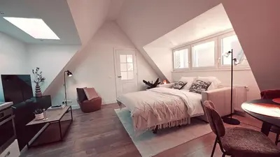 a bedroom with a bed and a table and a window at Tante Bed 44A in Voorschoten