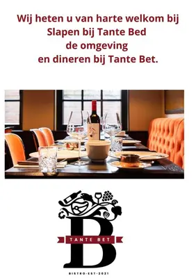 a restaurant with a table with a bottle of wine on it at Tante Bed 44A in Voorschoten