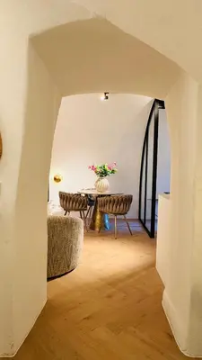 a room with a table with a vase of flowers at The Stork - In luxe logeren aan de Oudegracht, Centrum Utrecht in Utrecht