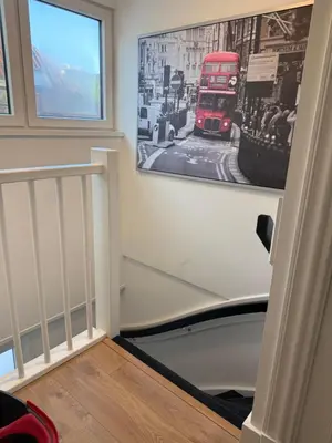 a stairway with a picture of a double decker bus at Tante Bed 44 B in Voorschoten