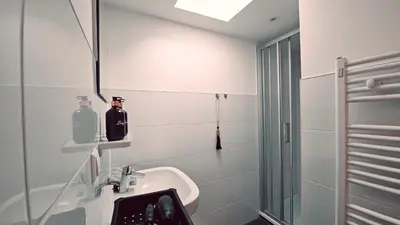 a bathroom with a sink and a shower at Tante Bed 44 B in Voorschoten