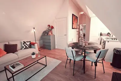 a living room with a couch and a table and chairs at Tante Bed 44 B in Voorschoten