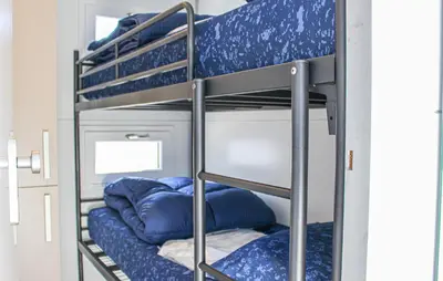 a bunk bed in a room with blue bunk beds at Havenlodge Lelystad in Lelystad