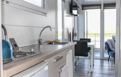 a kitchen with a sink and a counter top at Havenlodge Lelystad in Lelystad