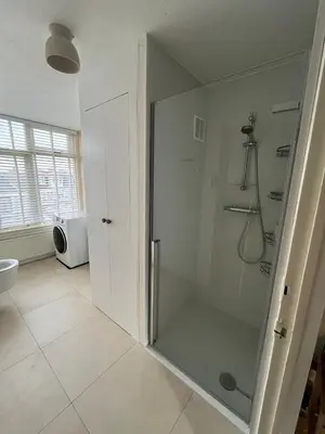 a bathroom with a shower with a glass door at Haarlem jaren' 30 huis Stad & Strand in Haarlem
