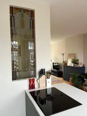 a kitchen with a black counter top in a room at Haarlem jaren' 30 huis Stad & Strand in Haarlem