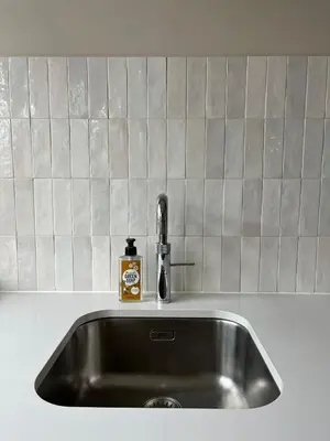 a kitchen sink with a soap dispenser on it at Haarlem jaren' 30 huis Stad & Strand in Haarlem