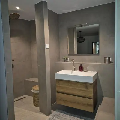 a bathroom with a sink and a mirror at Het Klokkenest in Katwijk aan Zee