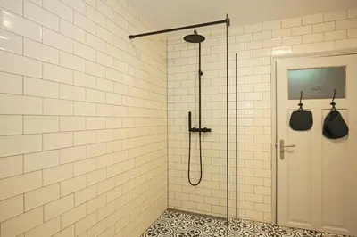 a shower with a glass door in a bathroom at Dok Apartments in Amsterdam