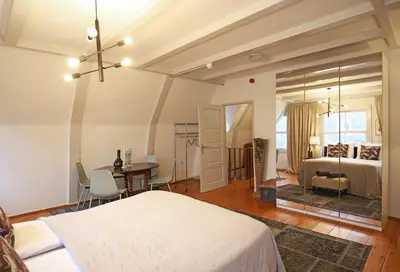 a bedroom with a bed and a table and chairs at Dok Apartments in Amsterdam