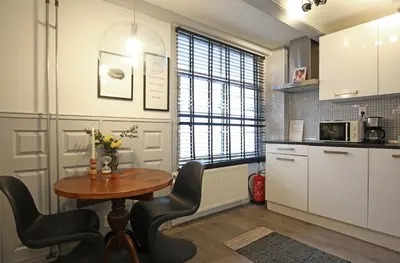 a kitchen with a table and chairs in a room at Dok Apartments in Amsterdam