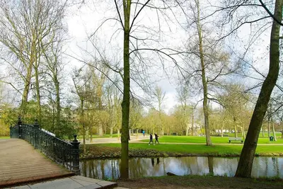 a park with a pond and trees and a boardwalk at Spacious Suite at Park and Museum in Amsterdam