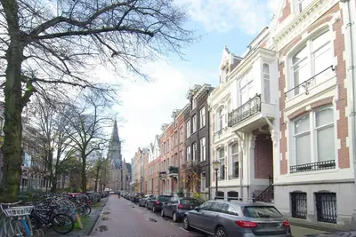 a city street with cars parked on the street at Spacious Suite at Park and Museum in Amsterdam
