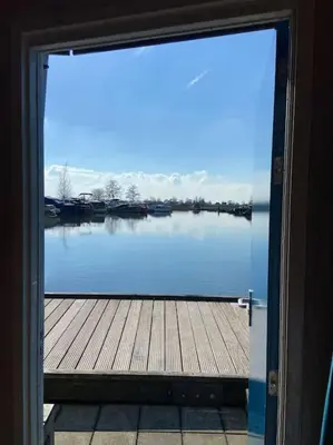 a door with a view of a body of water at Dobberhuisje in IJsselstein