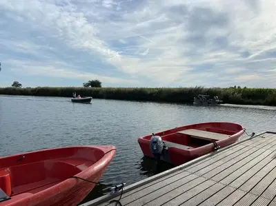 two boats are docked at a dock on a lake at Dobberhuisje in IJsselstein