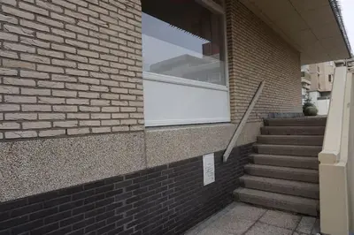 a window on the side of a brick building with stairs at Zen Beach Apartment in Noordwijk aan Zee