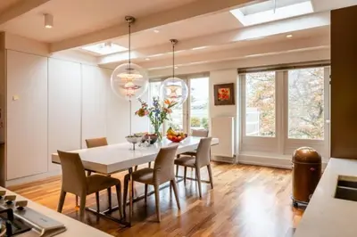 a dining room with a white table and chairs at The Elegant Amsterdam Apartment in Amsterdam