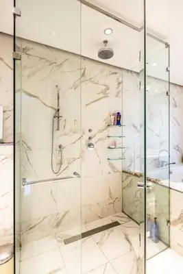 a shower with a glass door in a bathroom at The Elegant Amsterdam Apartment in Amsterdam