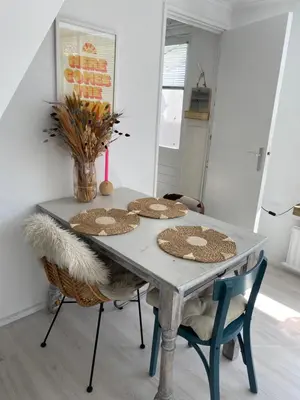 a table with straw hats on it in a room at Lola's Beachhouse in Noordwijk aan Zee