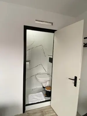 a white bathroom with a toilet in a room at Amsterdam Soul Inn in Amsterdam