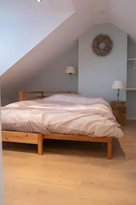 a bedroom with a bed in a attic at Julia's Holidayhome in Egmond-Binnen