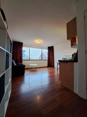a kitchen and living room with a large window at Apartments, 20 minutes from Amsterdam, Full service objectcode UM46 in Uitgeest