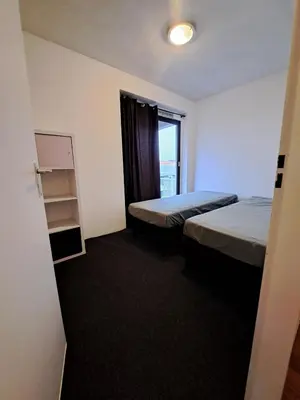 a hotel room with two beds and a window at Apartments, 20 minutes from Amsterdam, Full service objectcode UM46 in Uitgeest