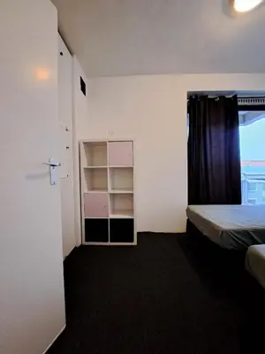 a small room with a bed and a closet at Apartments, 20 minutes from Amsterdam, Full service objectcode UM46 in Uitgeest