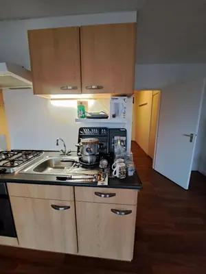 a kitchen with a sink and a stove top oven at Apartments, 20 minutes from Amsterdam, Full service objectcode UM46 in Uitgeest