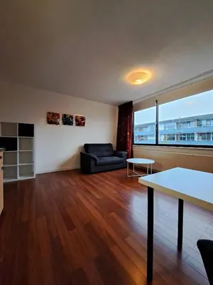 a living room with a couch and a table at Apartments, 20 minutes from Amsterdam, Full service objectcode UM46 in Uitgeest