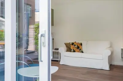 a living room with a white couch and a table at Blue Oasis Cottage - Free Parking in Zandvoort