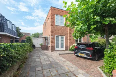 a car parked in front of a brick house at Blue Oasis Cottage - Free Parking in Zandvoort