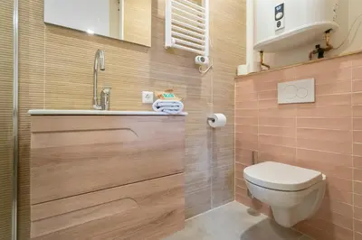 a small bathroom with a toilet and a sink at Skua Escape in Zandvoort
