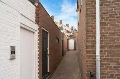 a narrow alley between two brick buildings at Skua Escape in Zandvoort