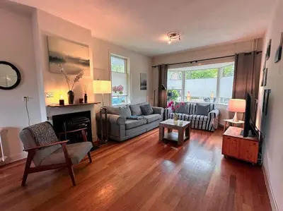 a living room with a couch and a fireplace at Charming villa,central location,train and bus nearby in Soest