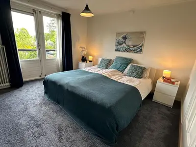 a bedroom with a large bed and a window at Charming villa,central location,train and bus nearby in Soest