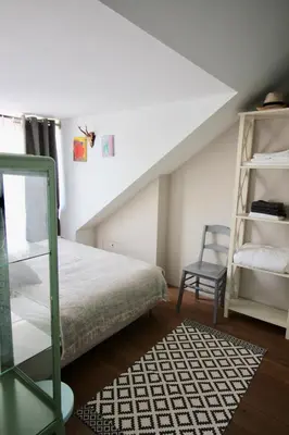 a bedroom with a bed and a ladder and a chair at Private room in Design House near Amsterdam in Halfweg