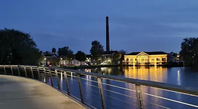 a building on a river next to a bridge at Private room in Design House near Amsterdam in Halfweg