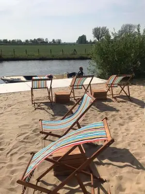 a group of chairs sitting on a sandy beach at Trek-in in IJsselstein