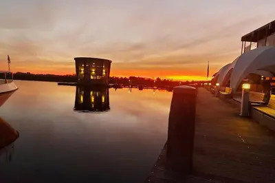 a sunset over a body of water with a dock at Trek-in in IJsselstein