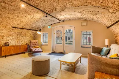 a living room filled with furniture and a brick wall at Luxurious renovated apartment in Utrecht City center with view on the old canal in Utrecht