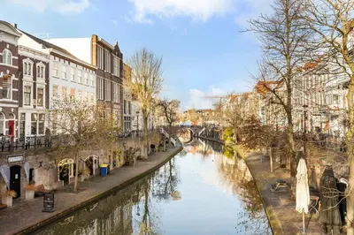 a river in a city with buildings next to a canal at Luxurious renovated apartment in Utrecht City center with view on the old canal in Utrecht