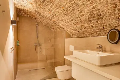 a bathroom with a sink and a shower at Luxurious renovated apartment in Utrecht City center with view on the old canal in Utrecht