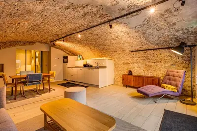 a large living room with a brick wall at Luxurious renovated apartment in Utrecht City center with view on the old canal in Utrecht