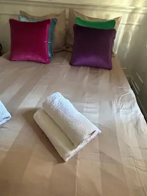 a bed with two pillows and a white blanket on it at Cosy by Mandy in Amsterdam