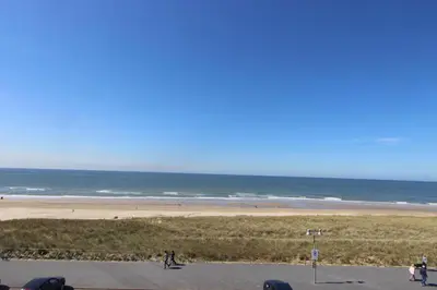 a view of a beach and the ocean at Appartement Atlantis met Zeezicht in Egmond aan Zee