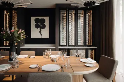 a dining room with a wooden table and chairs at Hilton Amsterdam Airport Schiphol in Schiphol