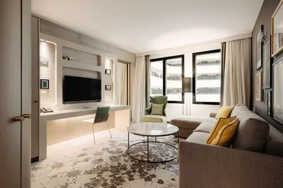 a living room with a couch and a table at Hilton Amsterdam Airport Schiphol in Schiphol