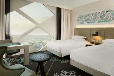 a hotel room with two beds and a window at Hilton Amsterdam Airport Schiphol in Schiphol
